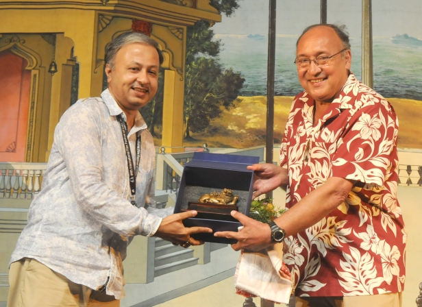 The International Jury Member Victor Banerjee felicitating the Assamese Film Maker Utpal Borpujari, at the Closing Ceremony of the North East Films, during the 44th International Film Festival of India (IFFI-2013), in Panaji, Goa .